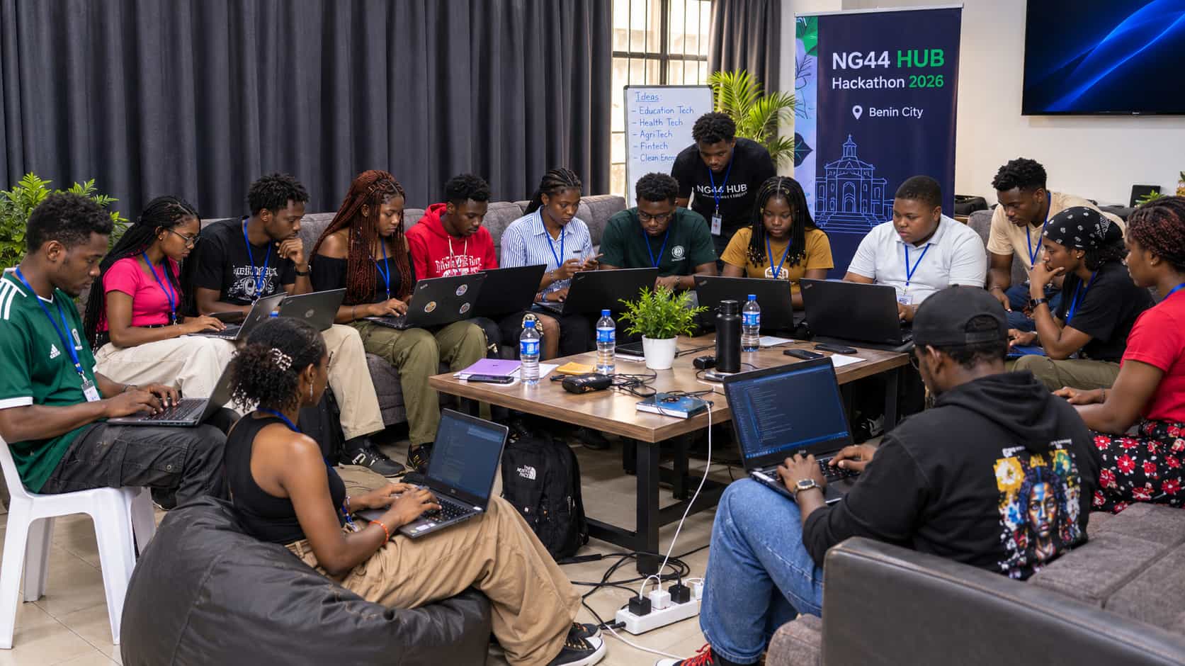Young people working on laptops during the Benin City hackathon