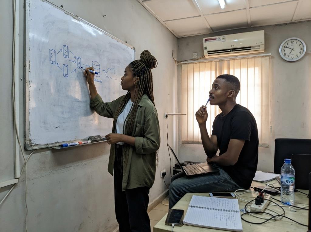 Developers planning a system on a whiteboard